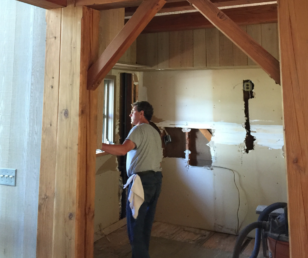 We left the wood beams in place but by removing the barn-like support arms we relieved the interior of the "colonial" feel.