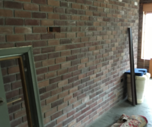 We cut out the center of this brick wall, making it a pass-through for the kitchen ad a place for bar stools. 