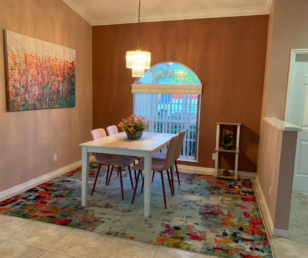 This is the dining room off the front entrance. Notice the rug is similar in style to the kitchen nook. I found the wall hanging at Home Goods and augmented it with acrylic paint to make it... 